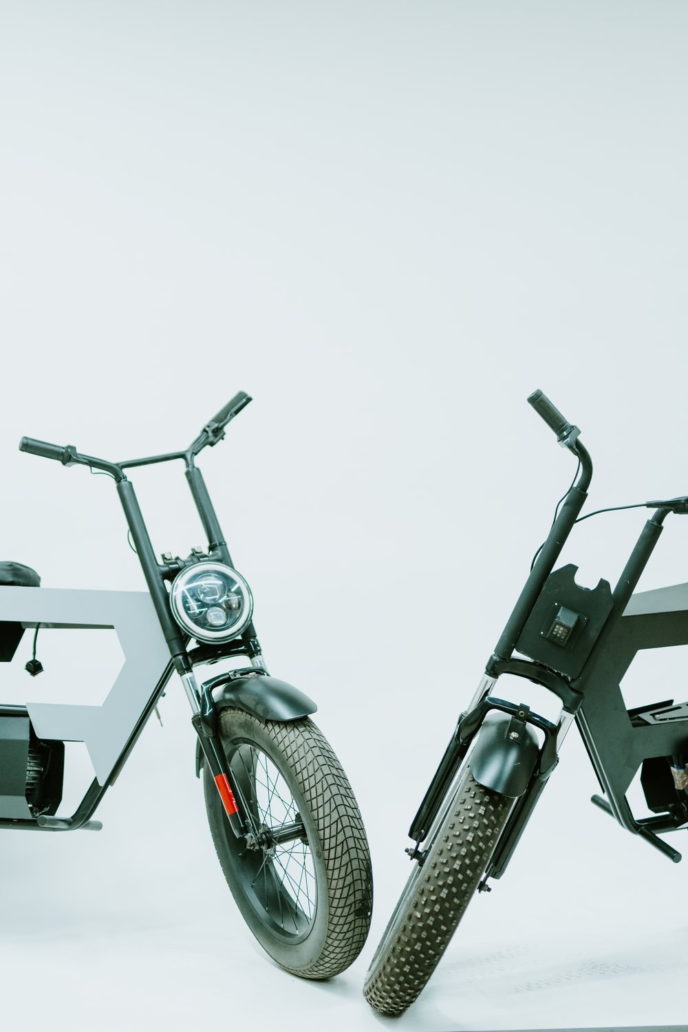 Two IntuitEVOLUTION electric vehicle platforms — a bare engineering chassis beside a built-up vehicle